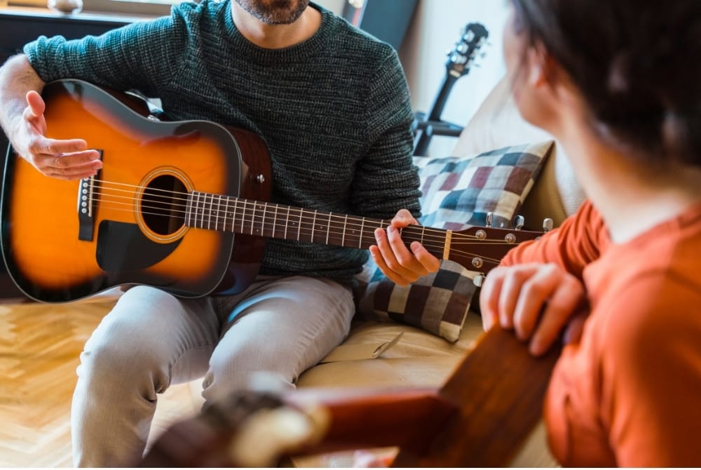 guitar student learning from guitar teacher